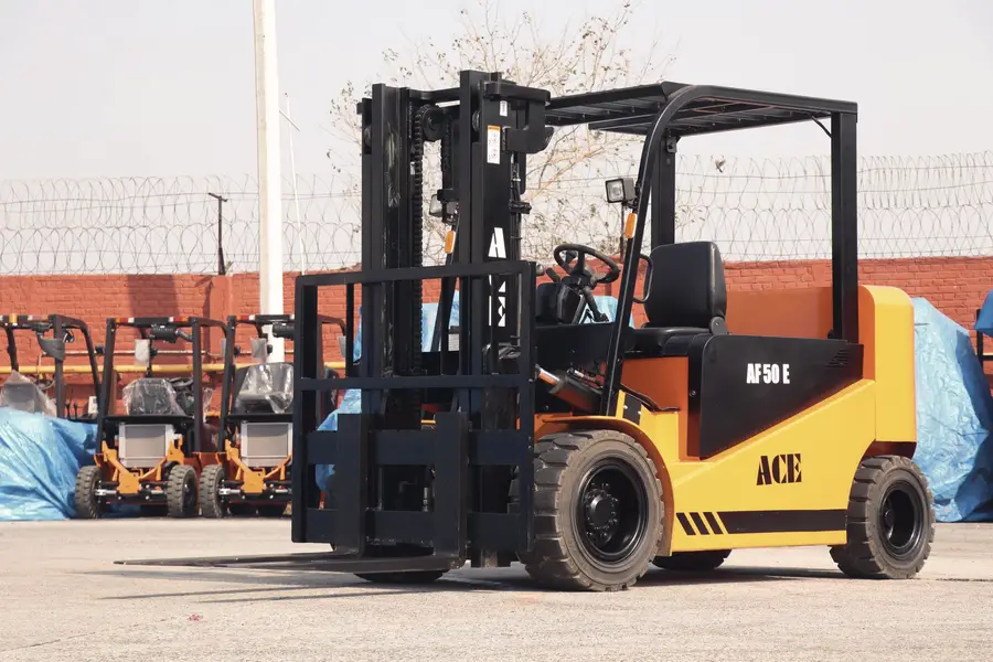 A forklift moving freight beside stacked shipping containers