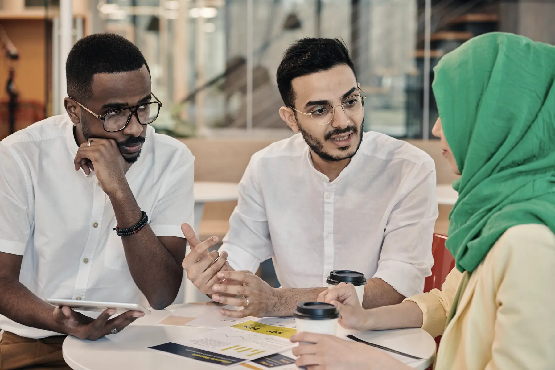 Colleagues in discussion around a table during a workshop